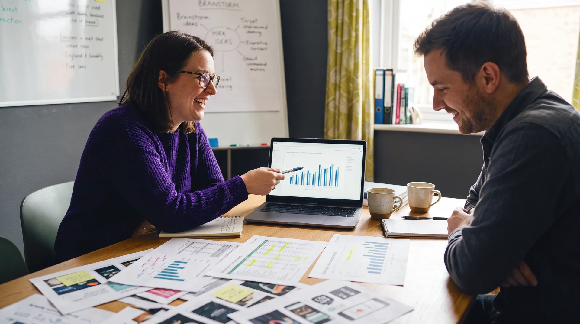 Colleagues reviewing AI marketing campaign results and performance metrics on laptop bar chart